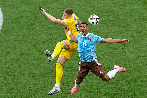 Youri Tielemans goes for the header with Artem Dovbyk